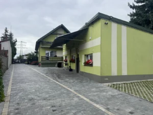 Podwórze z parkingiem i podjazdem między dwoma budynkami kwater pracowniczych